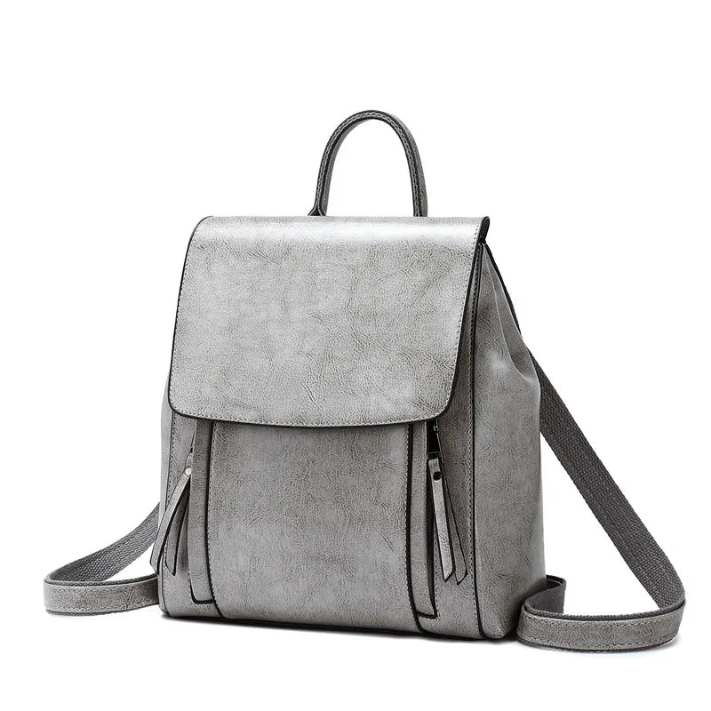 Stylish gray leather backpack with zipper pockets, adjustable straps and soft handle - front view