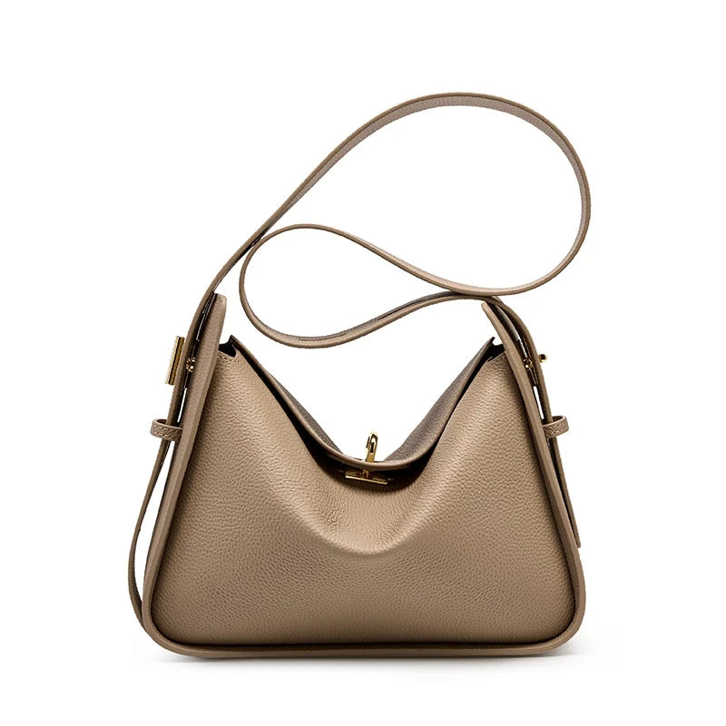 Elegant gray leather bag, with a modern design and long adjustable strap creating a casual look, front view.