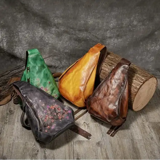 A collection of stylish leather shoulder bags in multiple colors with embossed floral design.