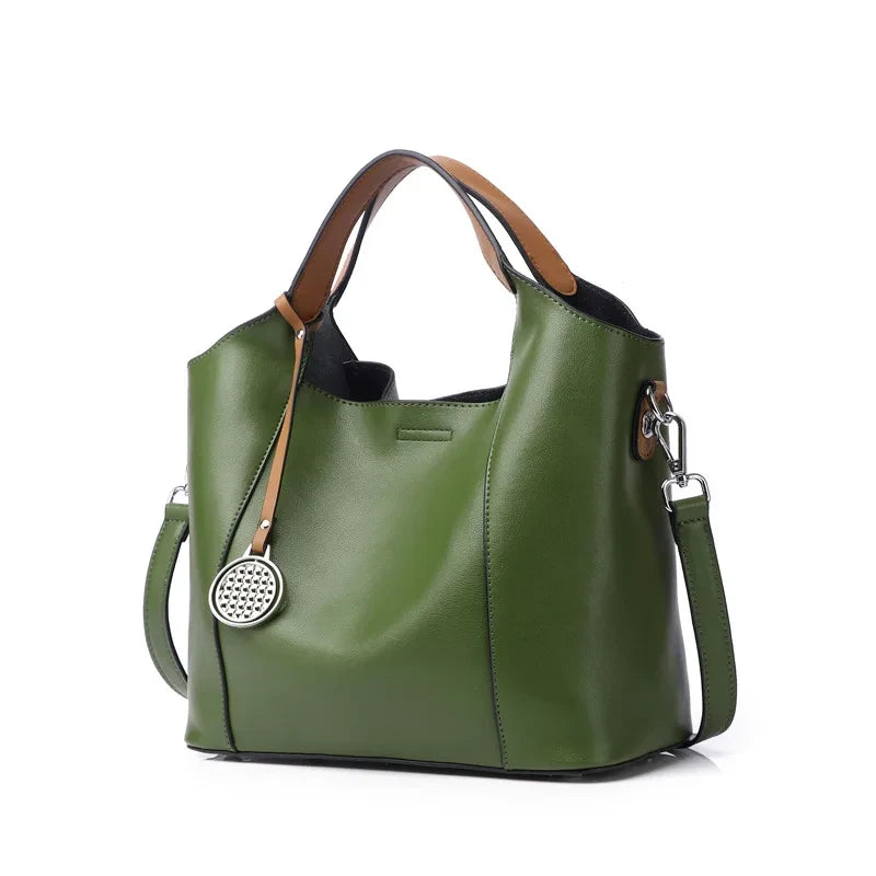 Army green leather bag with soft detachable soft handles and elegant charm.