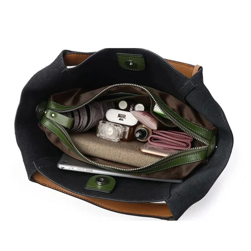 interior view of an army green leather bag showing main compartment with items and essentials.