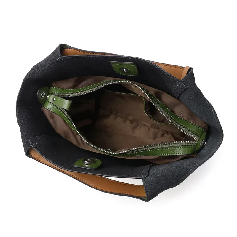 interior view of an army green leather bag showing main compartment and interior pockets.