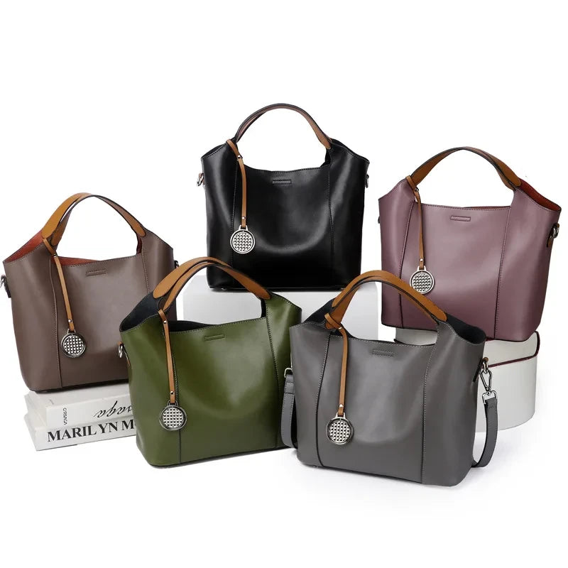Set of leather bags in different colors, including green, brown, black, gray and purple, front view.