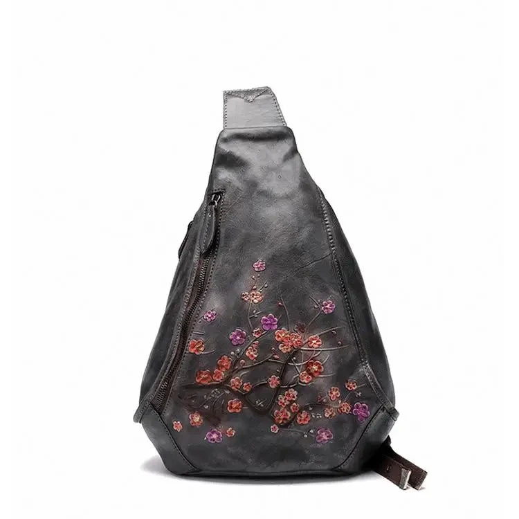gray leather shoulder bag featuring colorful flower embossed design - front view.