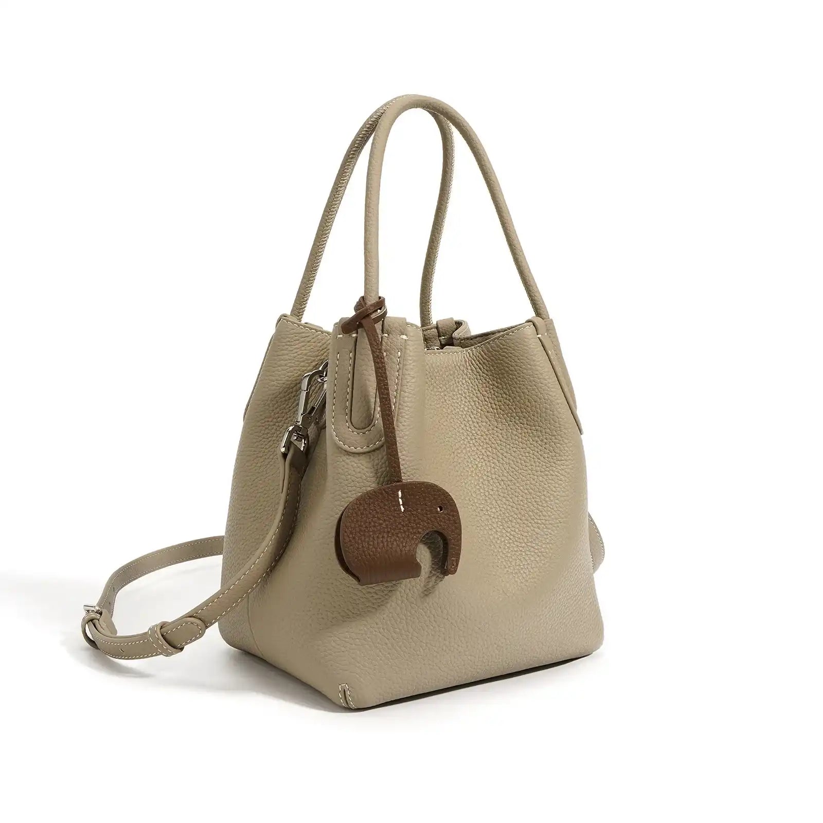 A stylish gray leather bucket bag with a unique elephant charm - front view.