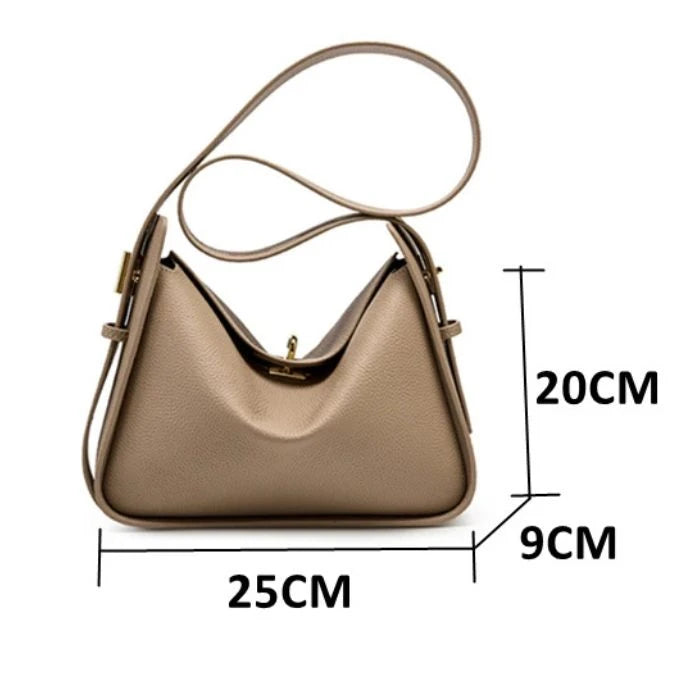 Women's leather bag in gray tone, measuring 25cm wide, 20cm high and 9cm deep, front view.