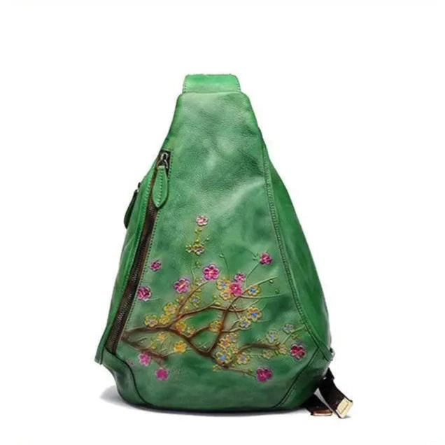 green leather shoulder bag featuring colorful flower embossed design - front view.
