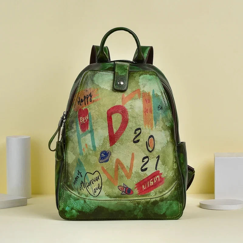 Green leather backpack with an artistic design filled with vibrant colors and drawings, front view.