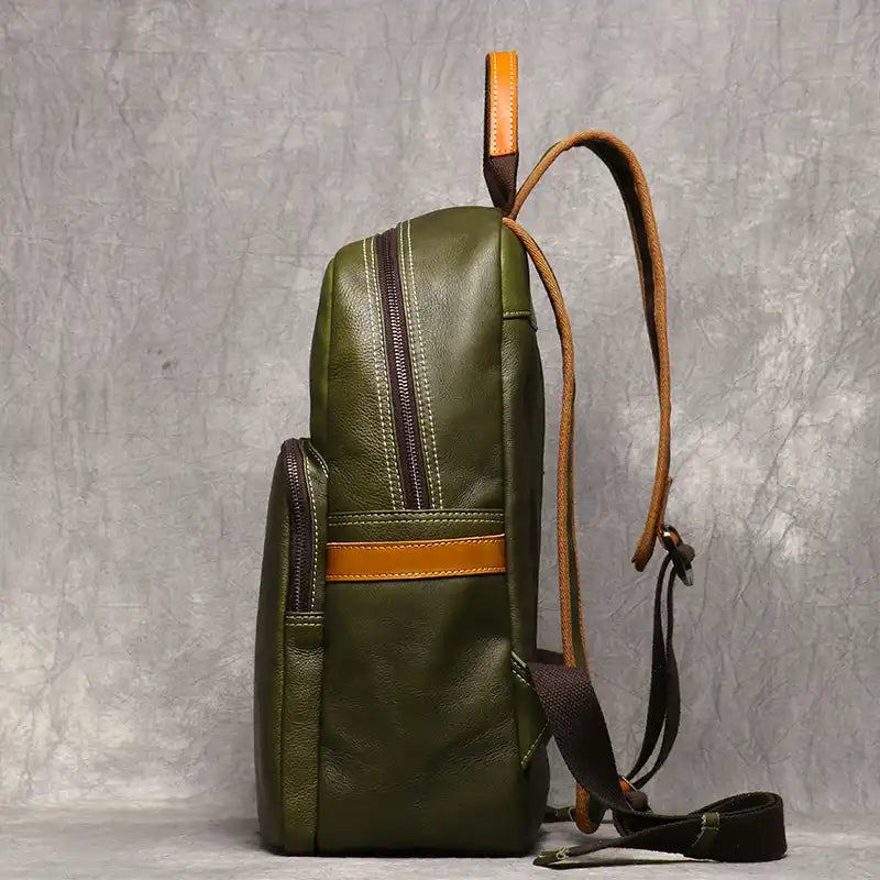 Fruit green leather backpack, with an elegant finish and practical side compartments, side view.