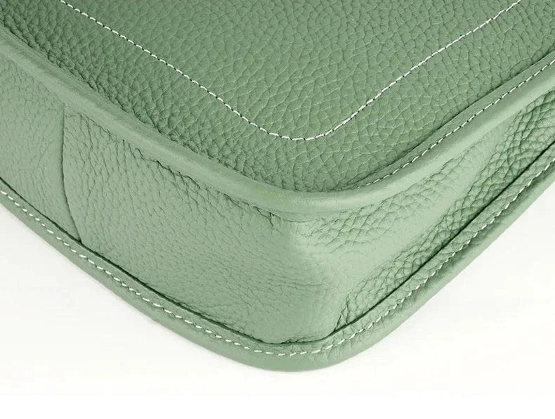 Close-up of the corner of a green leather bag with detailed stitching