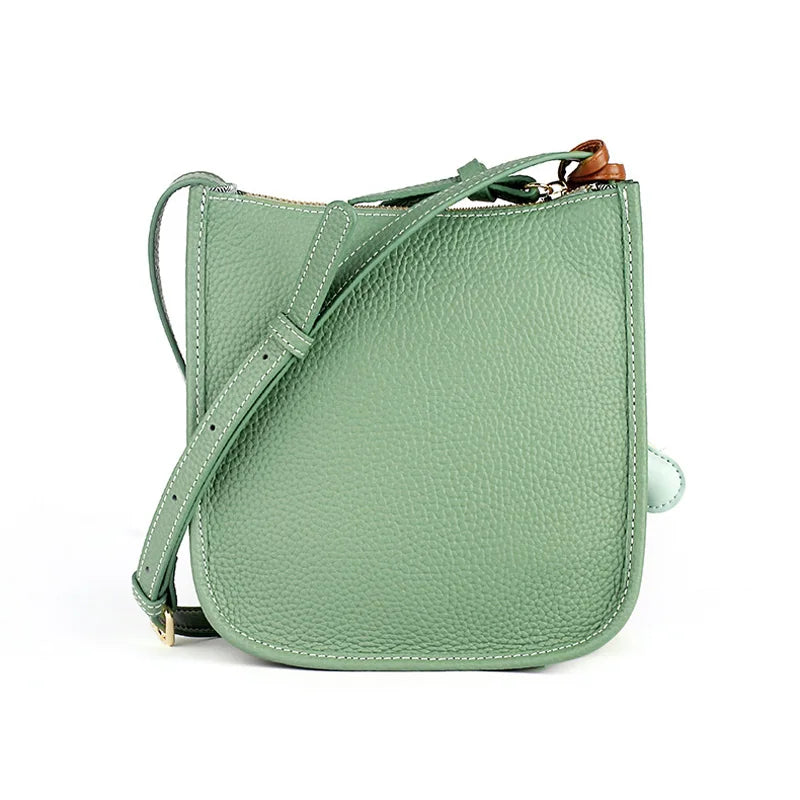 Back view of a stylish green leather crossbody bag with adjustable strap featuring high-quality leather