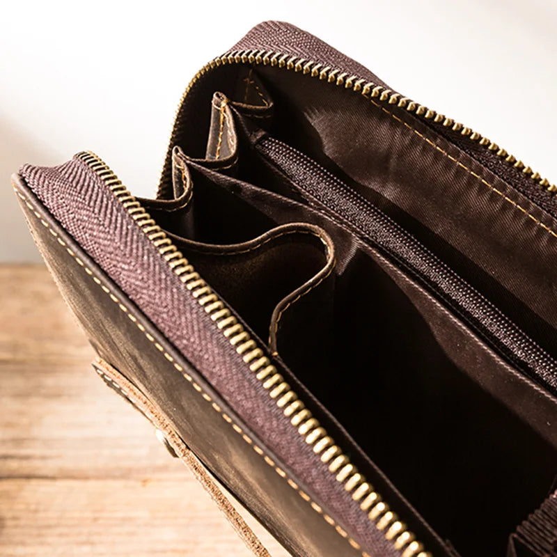 close-up of a brown leather wallet featuring a zipper and multiple compartments for cards and cash.
