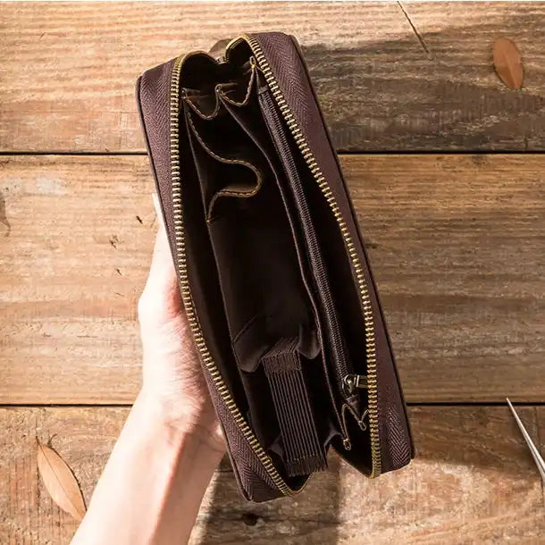 top view of a leather wallet with various interior pockets and compartments.