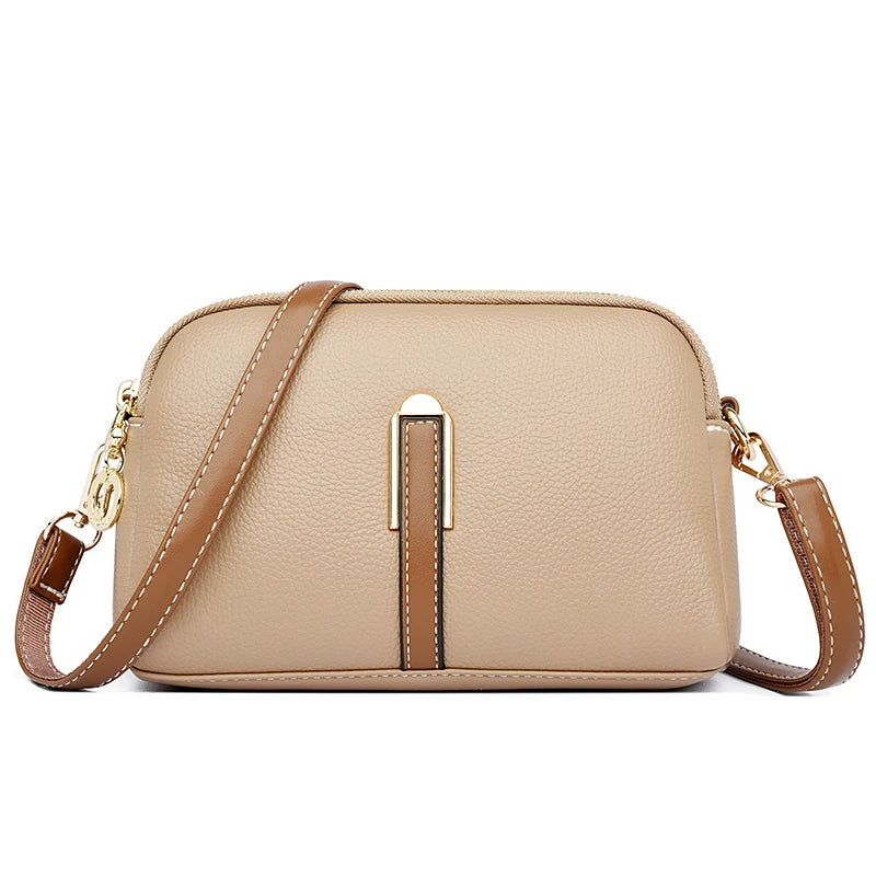 Chic khaki leather crossbody bag featuring a gold accent and a brown strap - front view.