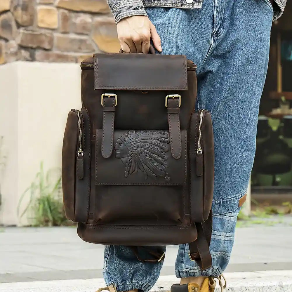 Brown leather backpack with elegant design of indigenous chief detail, ideal for everyday use or travel.