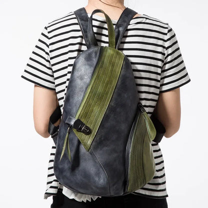 A stylish leather backpack with green and black design, worn by a person from the back.