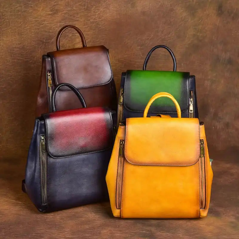Set of leather backpacks in different colors, including brown, red, green and yellow, with stylish and practical design.