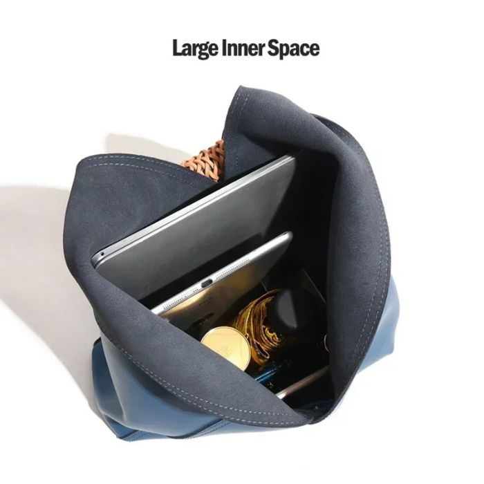 Interior view of a leather bag with a large internal space, capable of accommodating a tablet and other essential items.