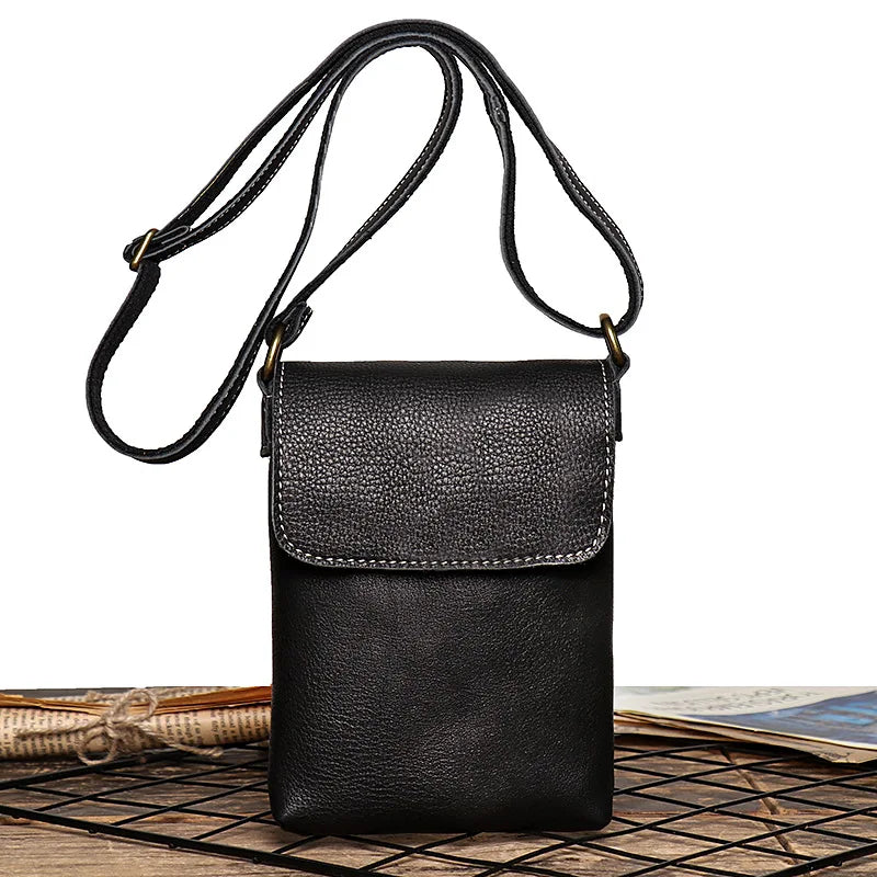 Vintage black leather mini shoulder bag with adjustable strap - front view