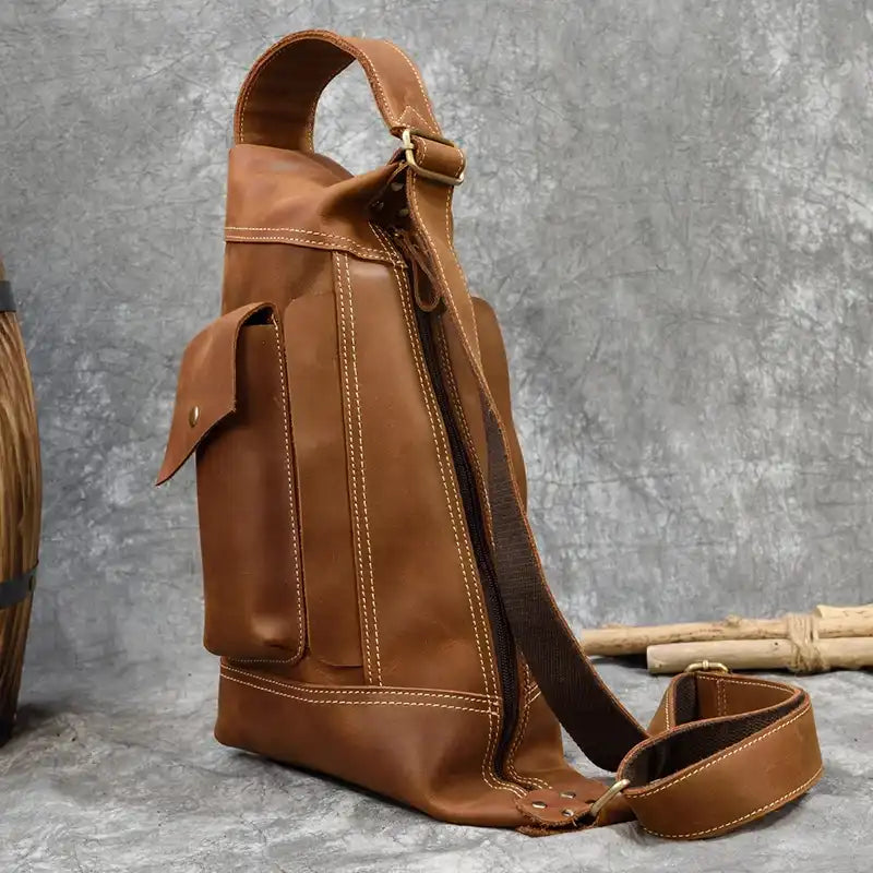 back view of a stylish light brown leather shoulder bag with adjustable strap - back view.
