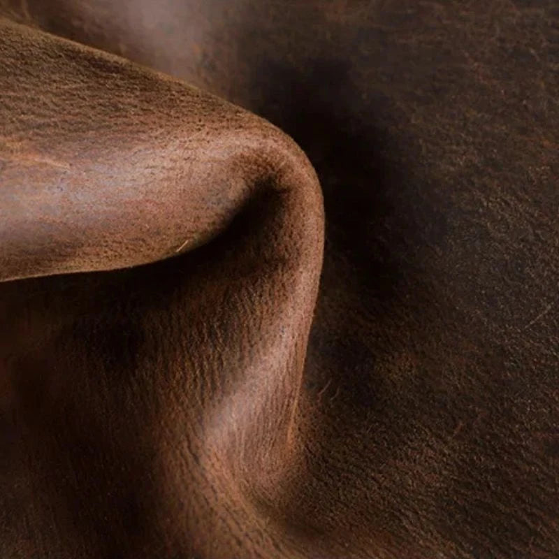 Detail of a brown leather fabric, showing the texture and contours that reveal the premium quality of the material.