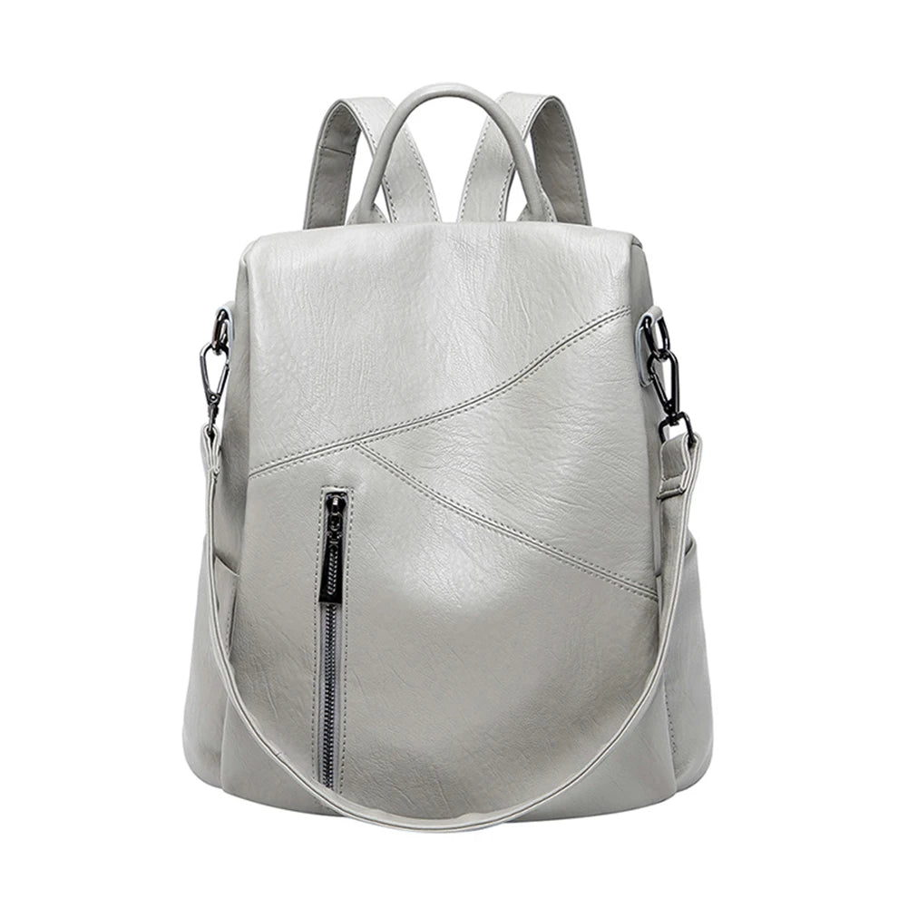 Trendy gray leather backpack featuring a sleek exterior and a front zip pocket - front view.