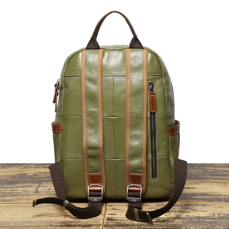 Pale green leather backpack, with an elegant finish and comfortable straps, back view.