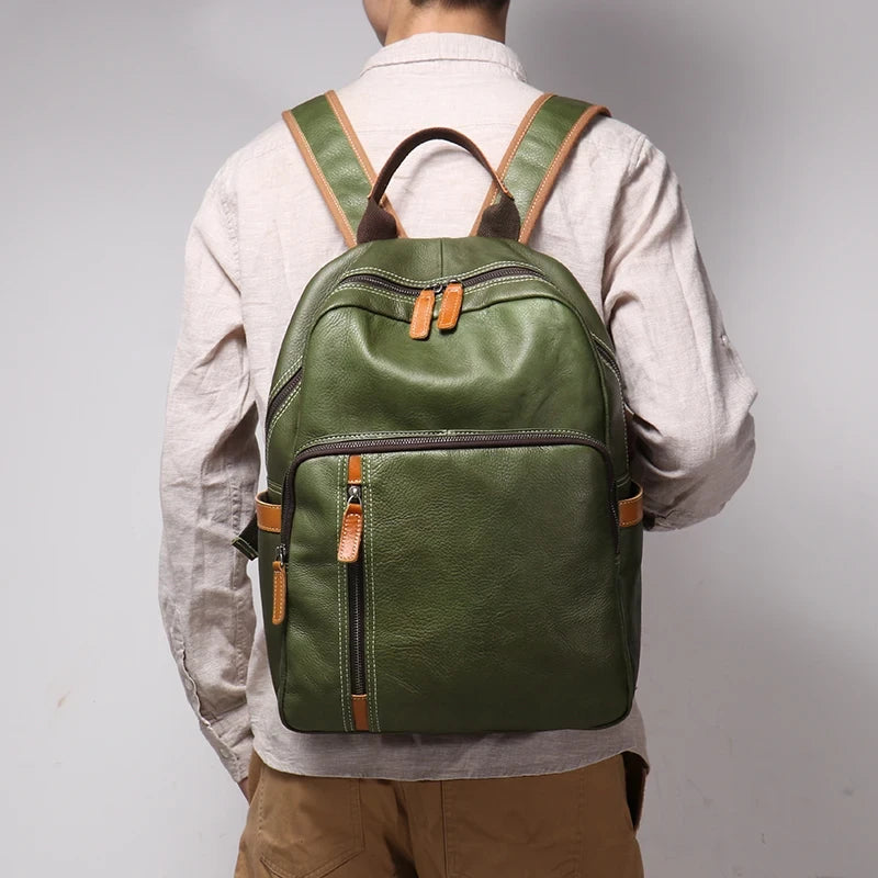 Green leather backpack worn on the back by a man wearing white shirt.