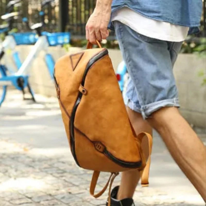 Man holding a stylish brown vintage  leather backpack with unique design, by hand.