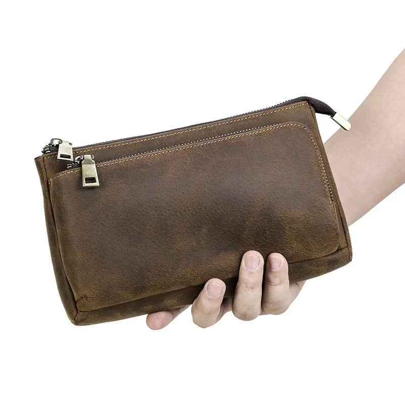 Brown leather clutch with zipper. Ideal for storing cards and daily essentials.