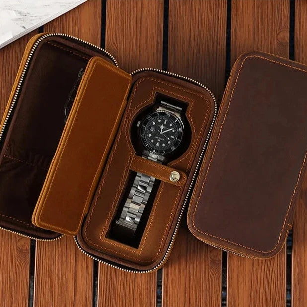 Close-up of a watch inside a leather case with a black watch inside.