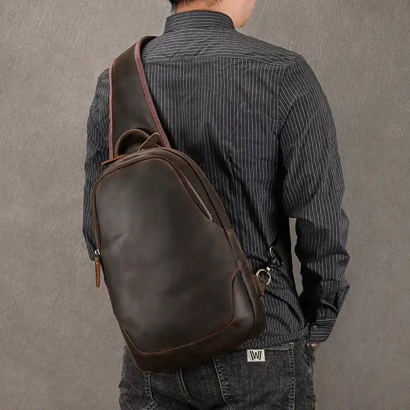 Man wearing a dark brown leather backpack, highlighting the modern and elegant bag design.
