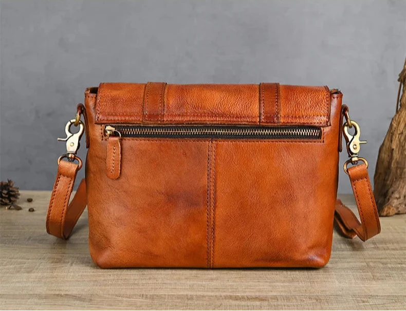 Elegant brown leather shoulder bag with adjustable strap and zipper - back view.