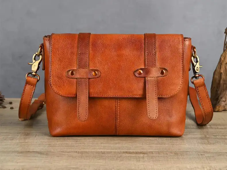 A chic brown leather shoulder bag featuring a flap closure and minimalist design - front view.