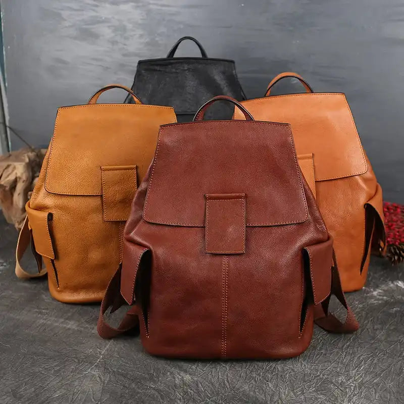 display of leather backpacks in different colors: brown, dark red and black, with an elegant and modern design.