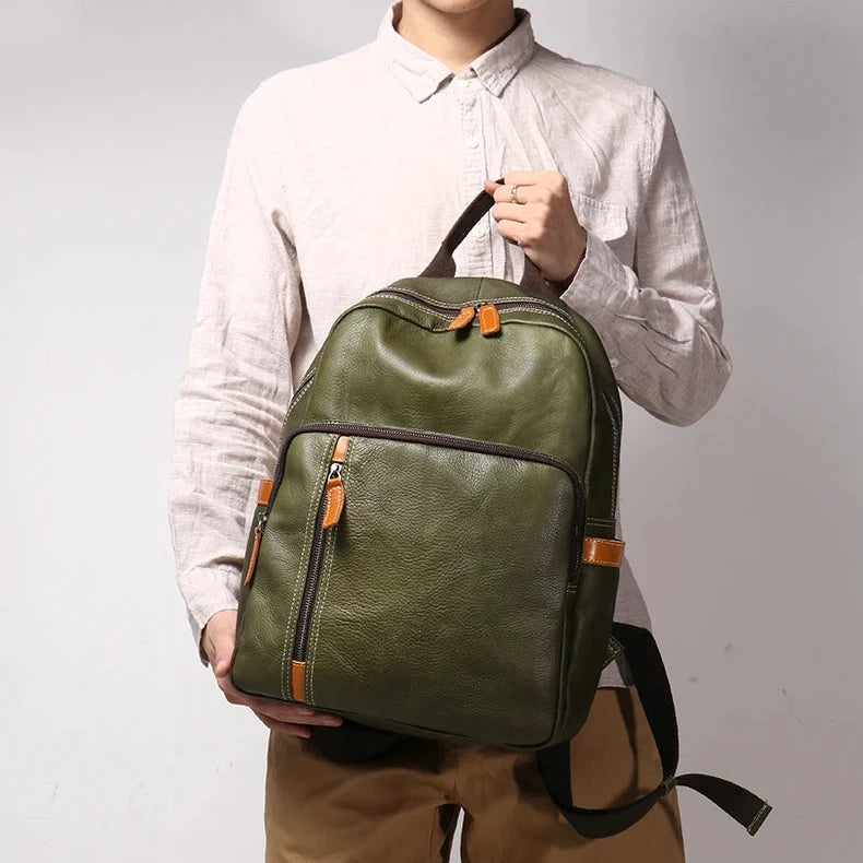 a man wearing white shirt holding a stylish green leather backpack.