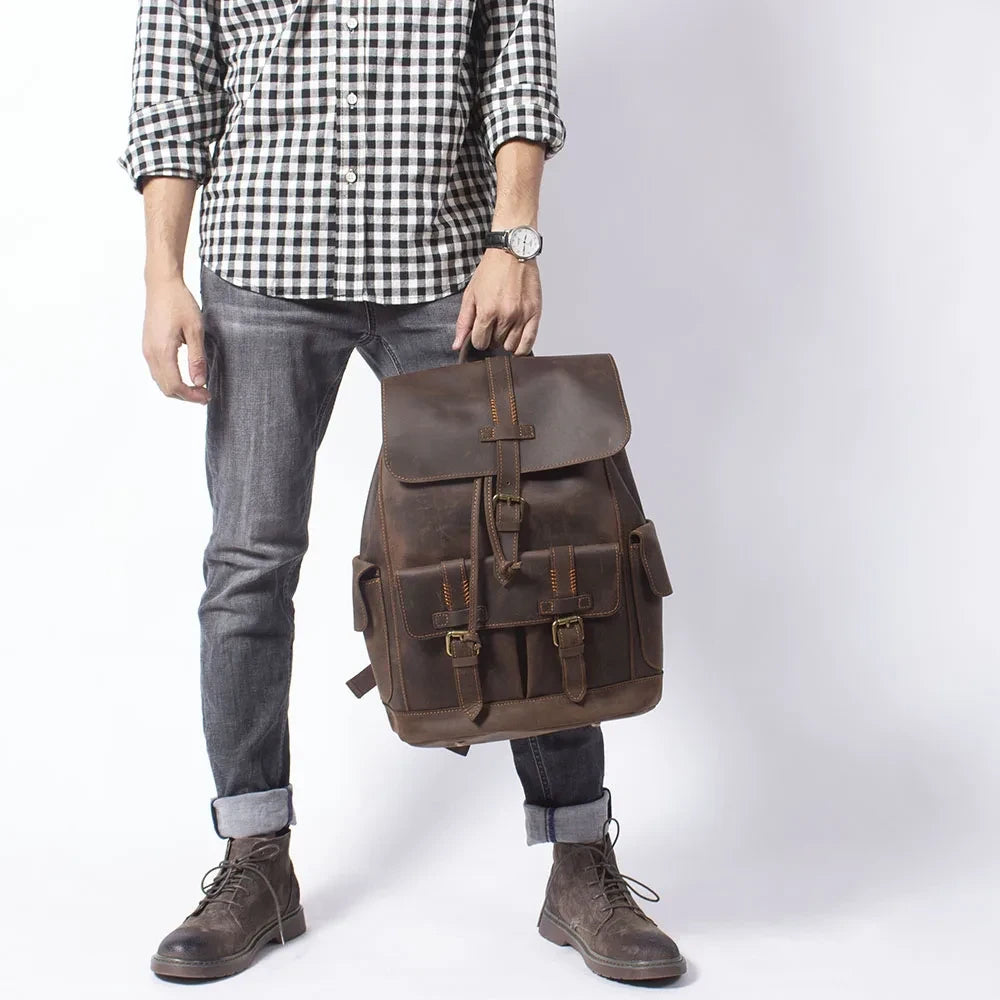 Fashionable brown backpack showcased by a man in casual outfit.