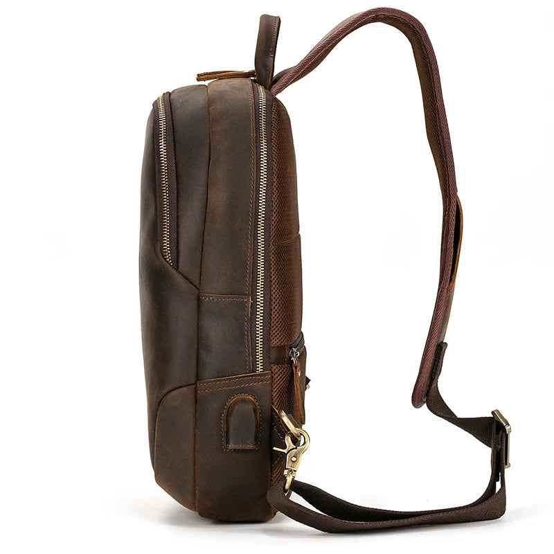side view of a stylish leather shoulder bag with zippers, adjustable strap and soft handle.