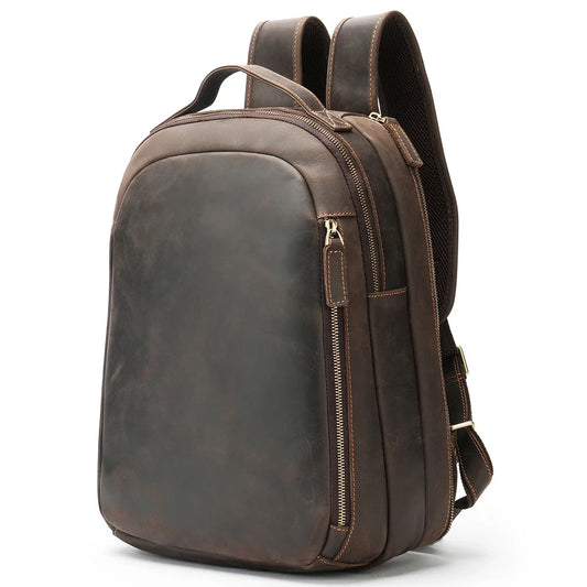 Stylish brown leather backpack with adjustable straps, soft handle and multiple compartments, front view.