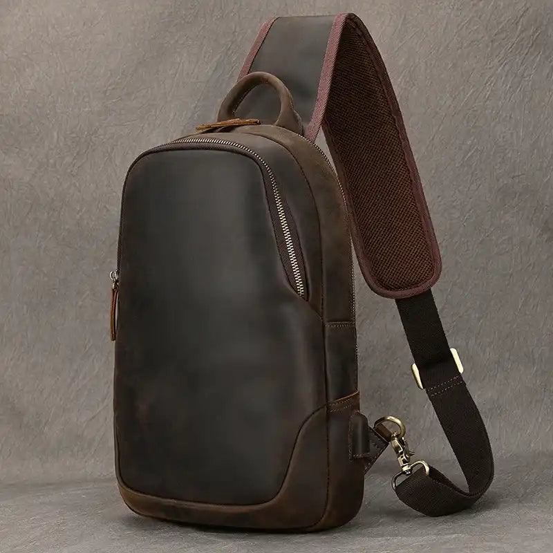 elegant dark brown leather shoulder bag with a modern design, adjustable strap, and soft handle - front view.