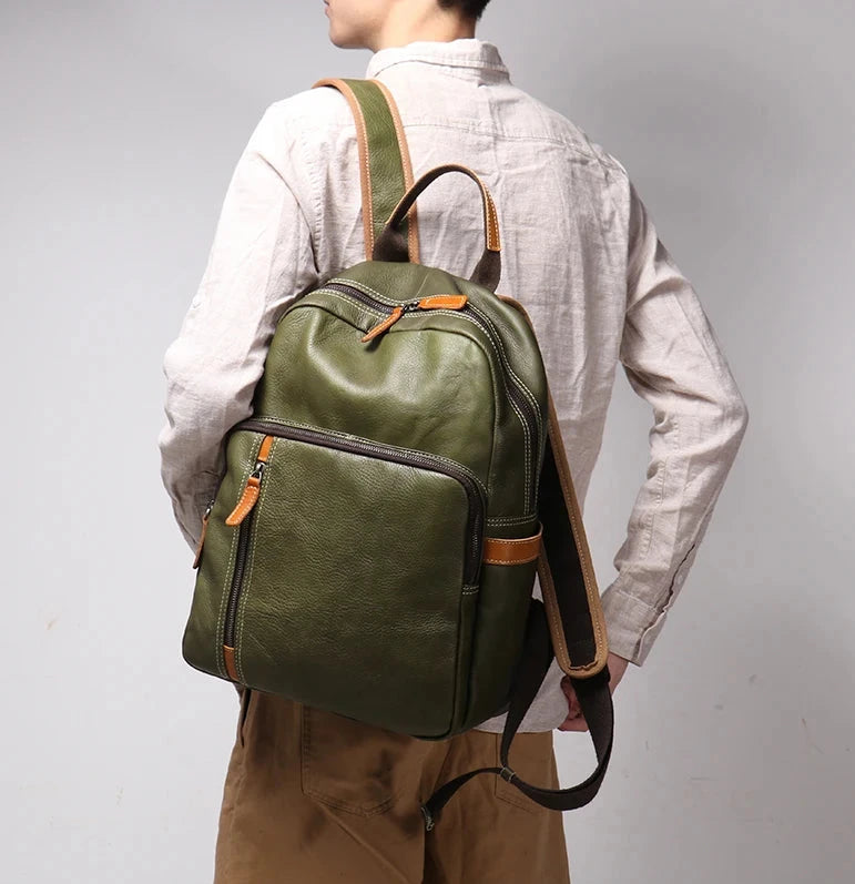 Green leather backpack worn on the shoulder by a man wearing white shirt.
