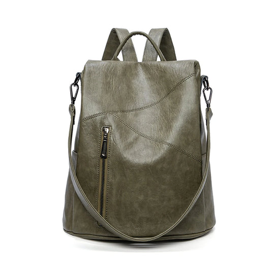 Trendy green leather backpack featuring a sleek exterior and a front zip pocket - front view.