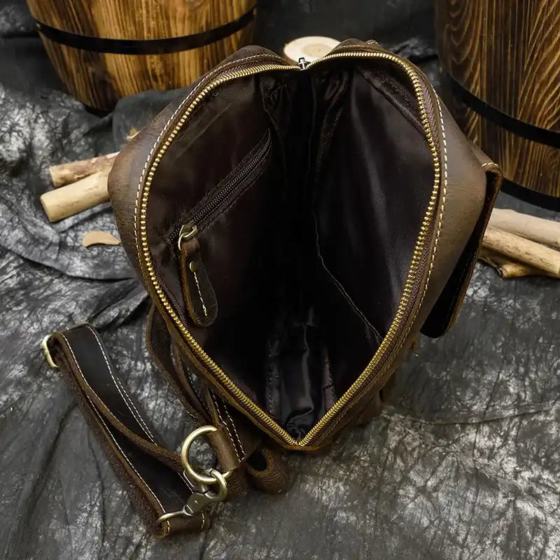 interior of a brown leather bag with zipper closure, showing interior space and lining details.
