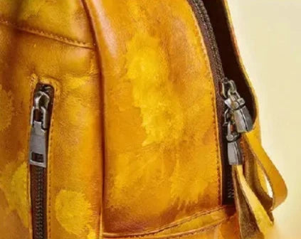 Orange backpack with floral details, and high-quality zippers.