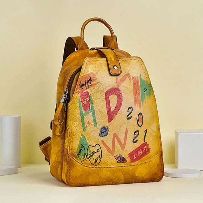 Orange leather backpack with an artistic design filled with vibrant colors and drawings, front view.