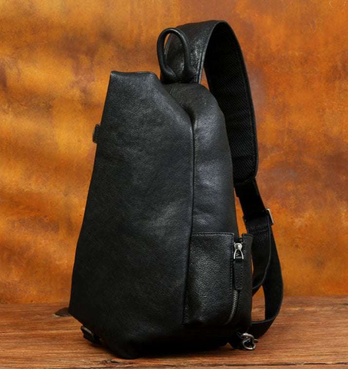 Modern black leather shoulder bag with an ergonomic design and adjustable straps - front view