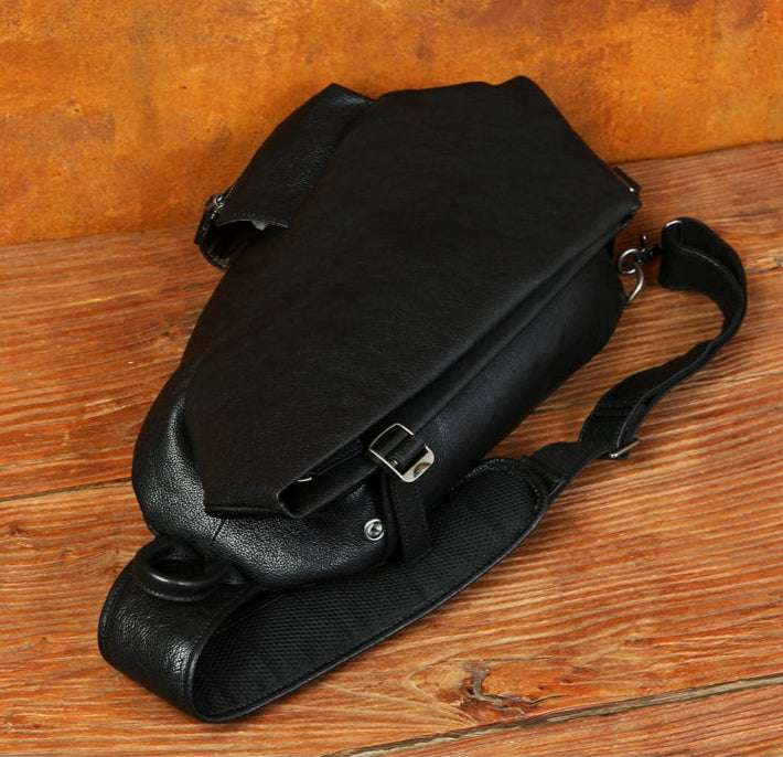 Ergonomic design of black leather shoulder bag with padded strap.