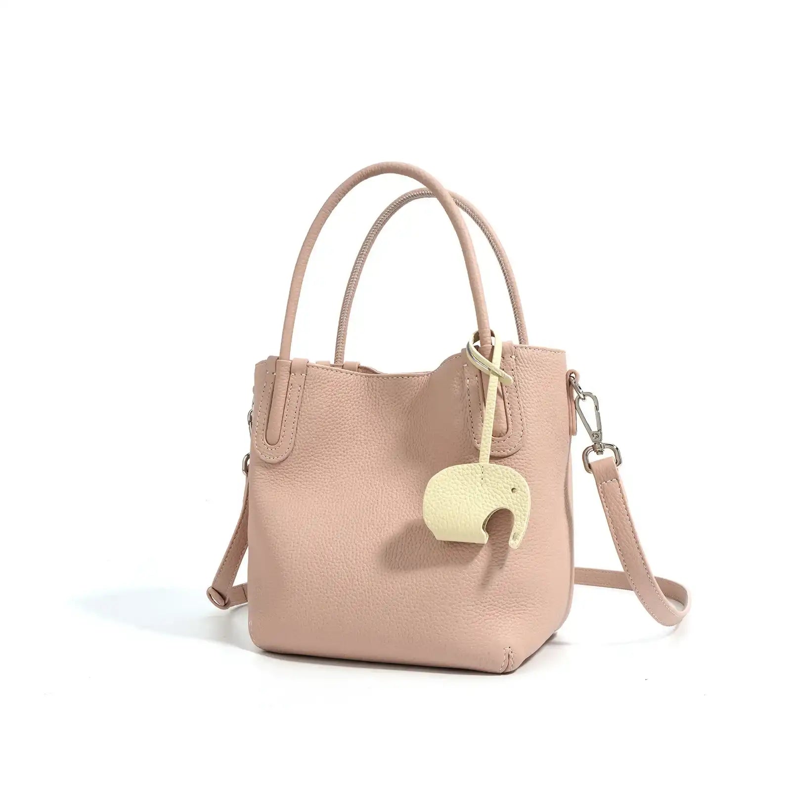 A stylish pink leather bucket bag with a unique elephant charm - front view.