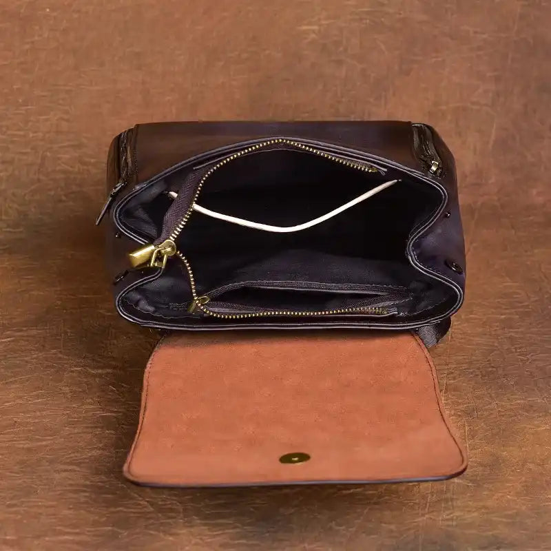 interior of an elegant leather bag with zipper, featuring a spacious interior and organized compartments.