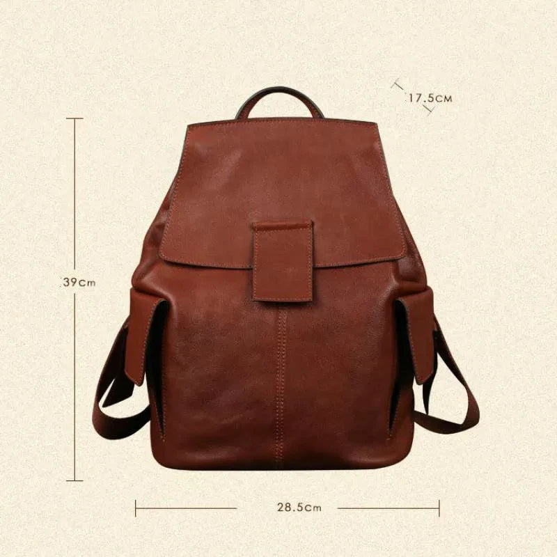 front view of a red brown leather backpack measuring 39 cm high, 28.5 cm wide, 17. cm deep, front view.
